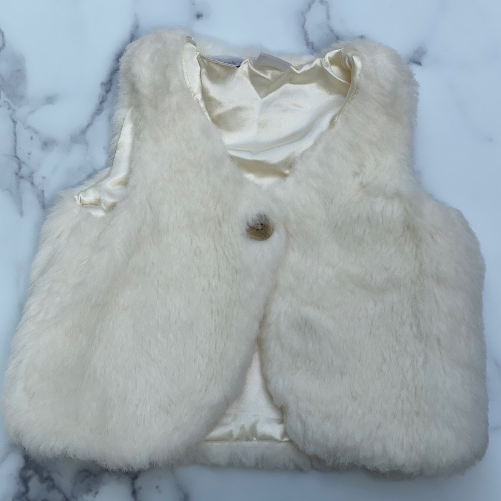 White fur vest